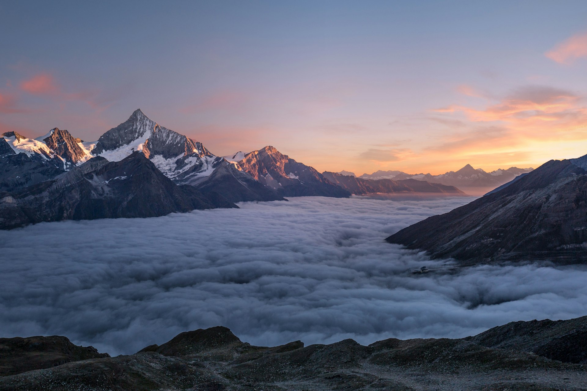 Breathtaking mountain sunrise with golden light over misty valleys