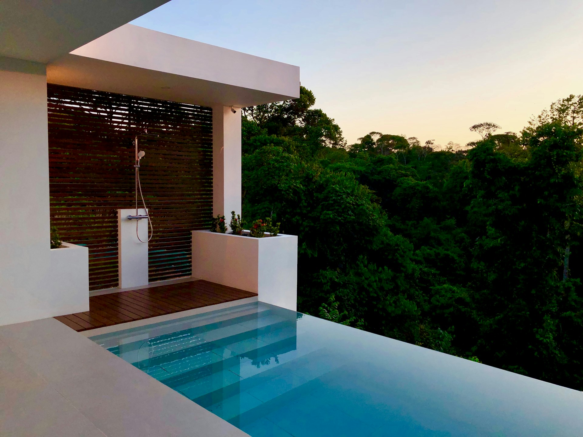Luxury eco-resort pool overlooking pristine natural landscape