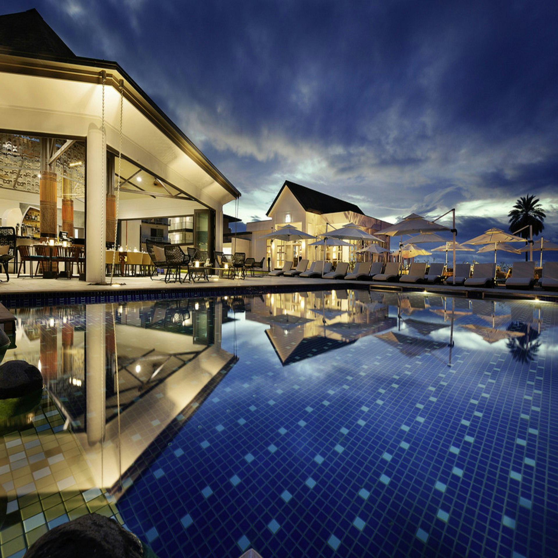 Luxury wilderness pool villa with panoramic forest view at sunset