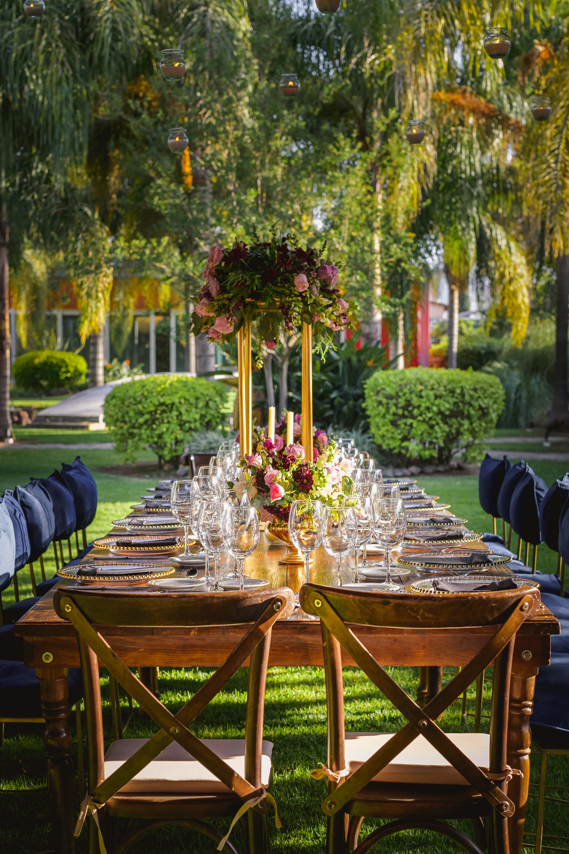 Luxury outdoor dining setup with candles and natural forest backdrop