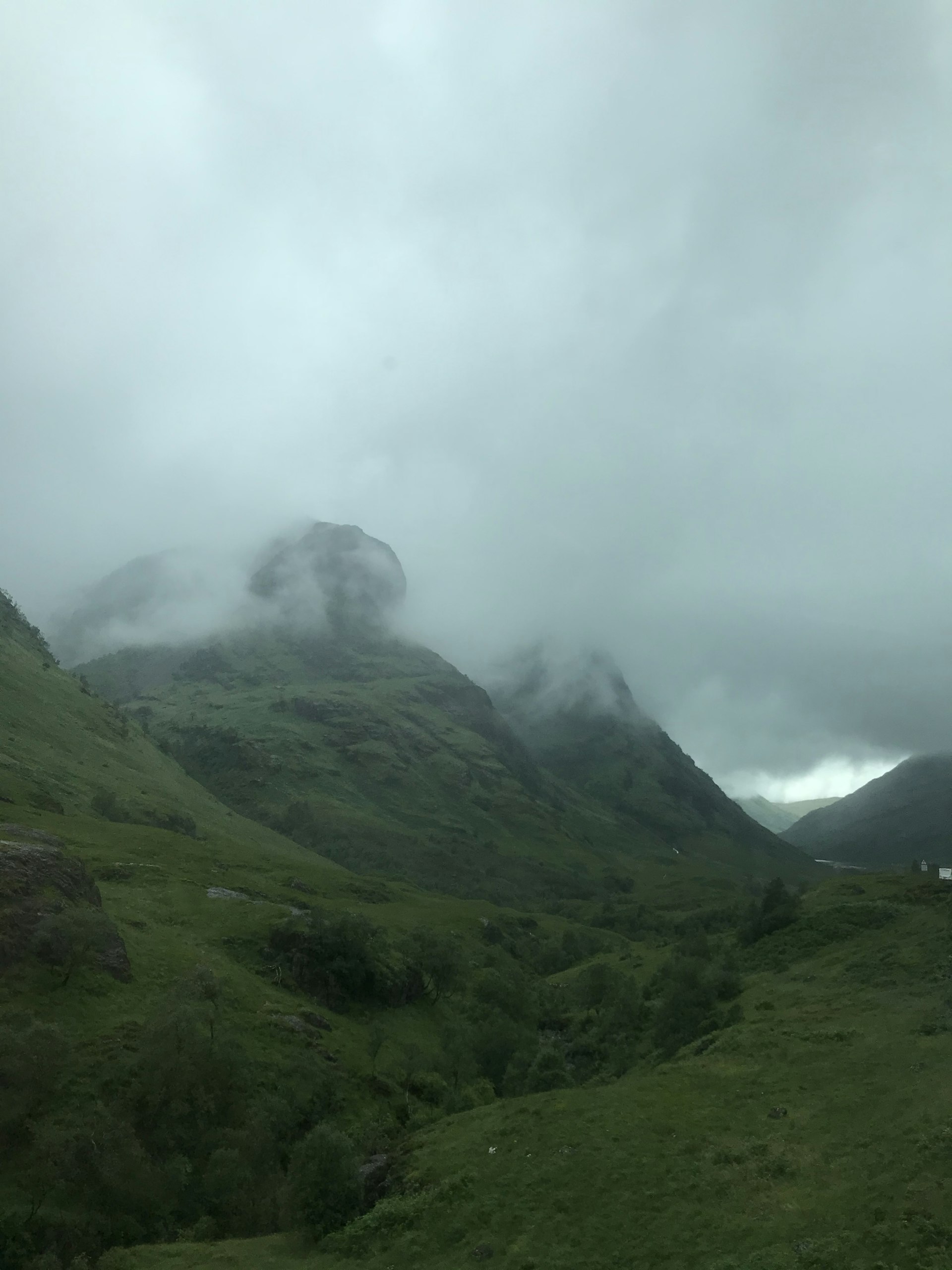 Misty mountain landscape with green valleys and dramatic clouds